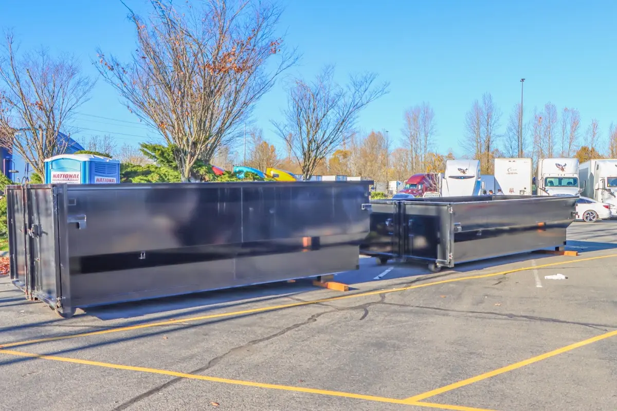 Professional dumpster rental service with roll-off container on residential driveway in Cobleskill